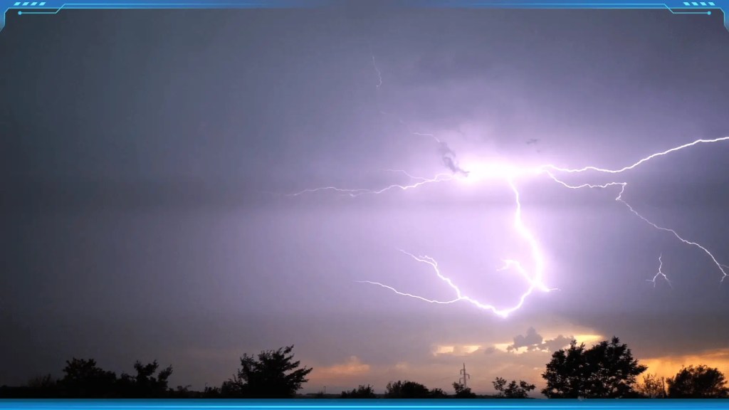 A brilliant flash of Lightning and Thunder illuminating a dark sky at sunset, caused by a sudden release of electrical charge in clouds.