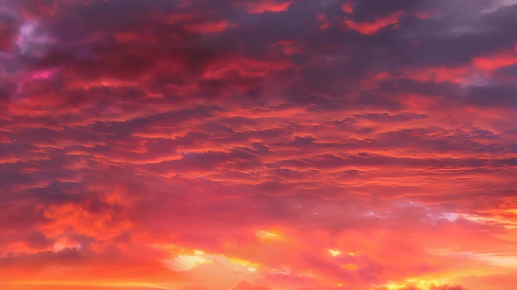 What Is Sunset? 1 A vibrant red and orange sky at sunset, showing clouds illuminated by the light of the setting sun.
